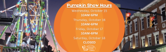 lighted ferris wheel next to special hours listed on pumpkin backdrop