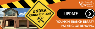 orange background with photo of library and under construction sign. 